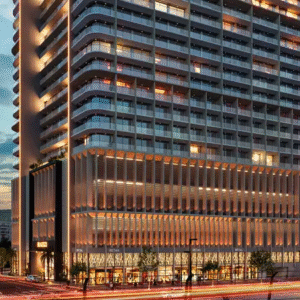 High-rise commercial and residential building exterior at sunset